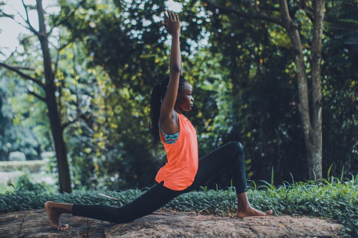 CREPS CRJS Centre Woman practicing yoga outdoors in a serene forest setting, embracing fitness and tranquility.